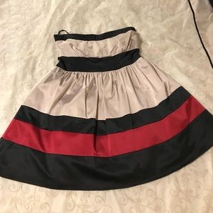 Mystic strapless dress. Black, tan, and red accent